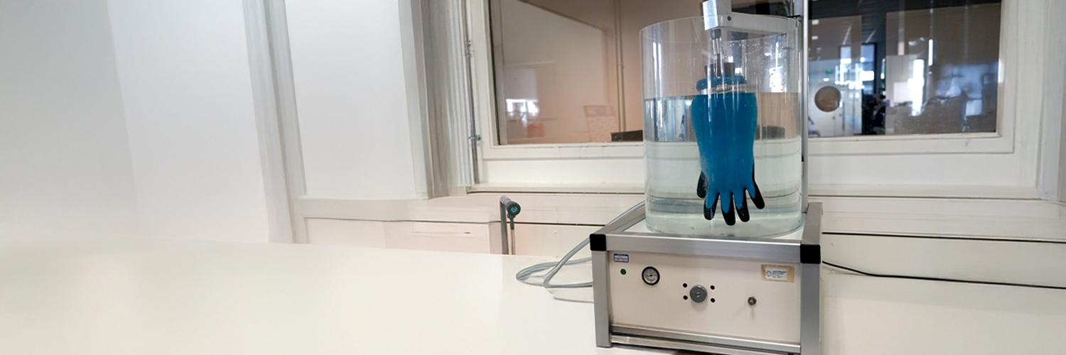 Gant bleu plongé dans un liquide